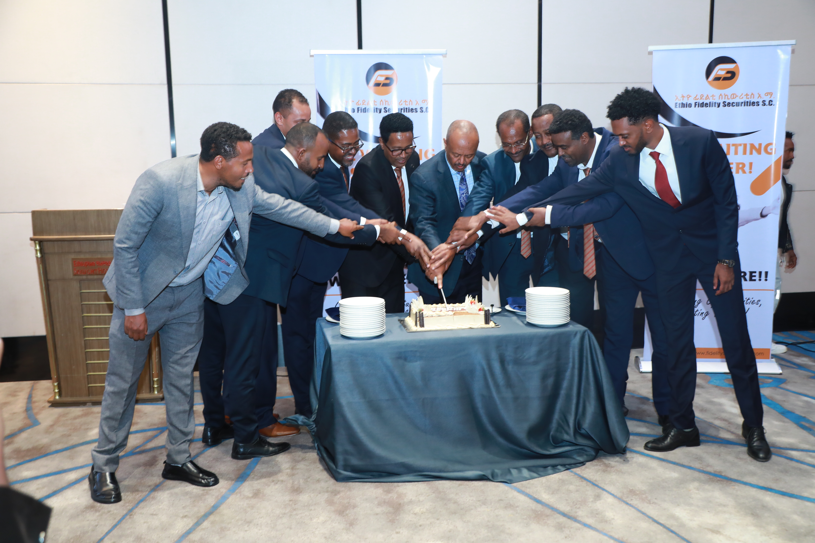 Ethio Fidelity directors and staff cutting a cake at the firm's launch event